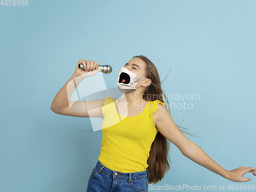 Image of Portrait of young caucasian girl with emotion on her protective face mask