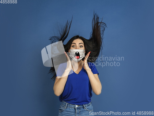 Image of Portrait of young caucasian woman with emotion on her protective face mask