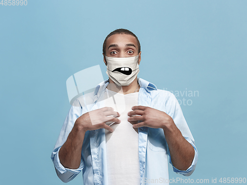 Image of Portrait of young african-american man with emotion on his protective face mask