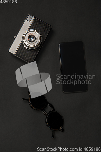 Image of Gadgets and eyewear. Monochrome stylish composition in black color. Top view, flat lay.