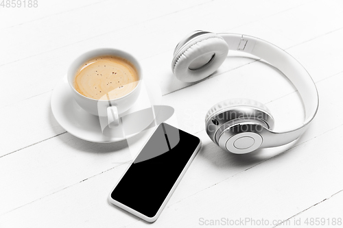 Image of Gadgets and coffee. Monochrome stylish composition in white color. Top view, flat lay.