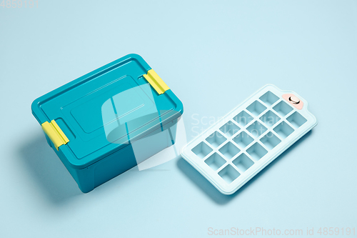 Image of Closed lunch box, ice form. Monochrome stylish composition in blue color. Top view, flat lay.