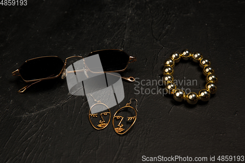 Image of Fashion look. Monochrome stylish composition in black and gold colors. Top view, flat lay.