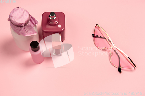 Image of Cosmetics, fashion. Monochrome stylish composition in pink color. Top view, flat lay.