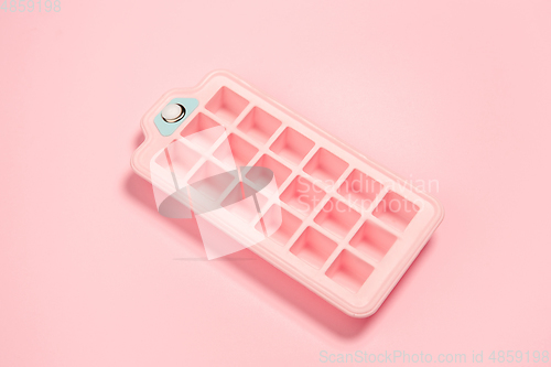 Image of Ice form. Monochrome stylish composition in pink color. Top view, flat lay.