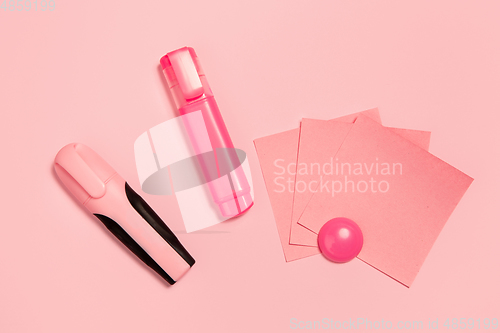 Image of Markers and paper stickers. Monochrome stylish composition in pink color. Top view, flat lay.