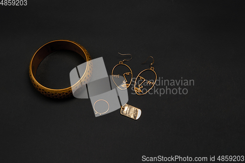 Image of Fashion look. Monochrome stylish composition in black and gold colors. Top view, flat lay.