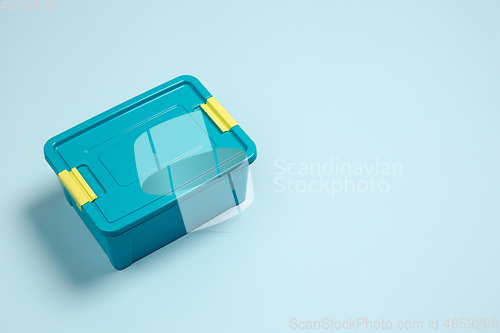 Image of Closed lunch box. Monochrome stylish composition in blue color. Top view, flat lay.