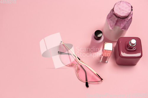 Image of Cosmetics, fashion. Monochrome stylish composition in pink color. Top view, flat lay.