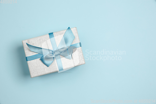 Image of Gift, present box. Monochrome stylish composition in blue color. Top view, flat lay.