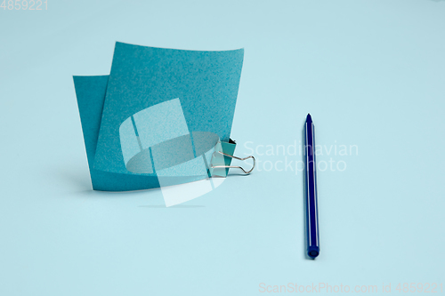 Image of Sticker paper, pen. Monochrome stylish composition in blue color. Top view, flat lay.