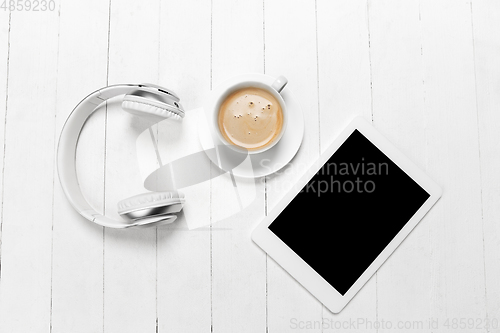 Image of Gadgets and coffee. Monochrome stylish composition in white color. Top view, flat lay.