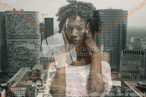 Image of Stressed woman holding head with hands on abstract city background. Double exposure. Virus alert, coronavirus pandemic.