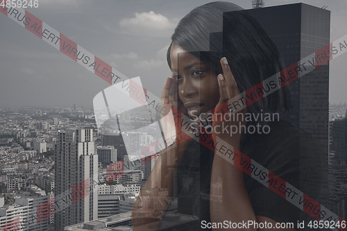 Image of Stressed woman holding head with hands on abstract city background. Double exposure. Virus alert, coronavirus pandemic.