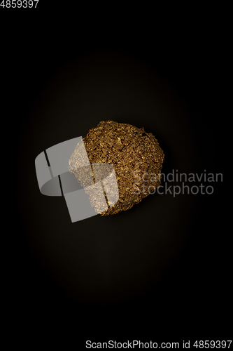Image of Golden stone on a black background, stylish minimalistic composition with copyspace