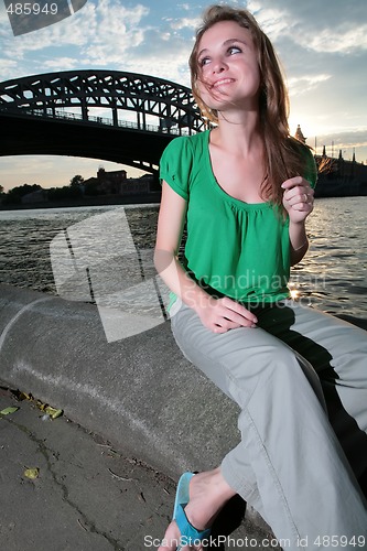 Image of merry girl near Moscow-river at night
