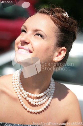 Image of smiling girl with pearl necklace