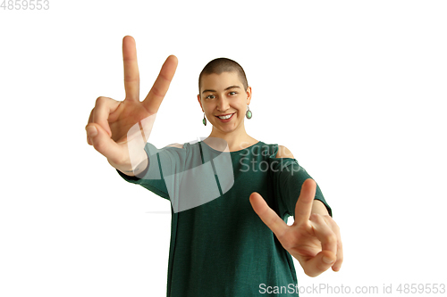 Image of Portrait of young woman with freaky appearance on white background