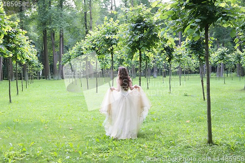 Image of girl walks in the summer park