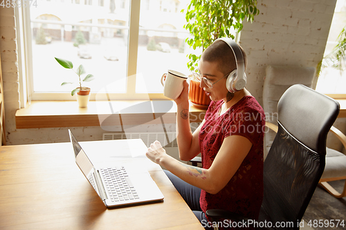 Image of Woman working from home during coronavirus or COVID-19 quarantine, remote office concept