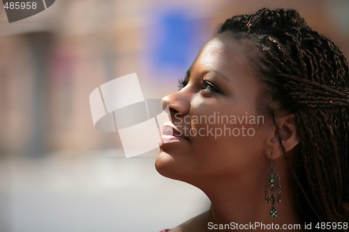 Image of black girl smiles to sunbeams