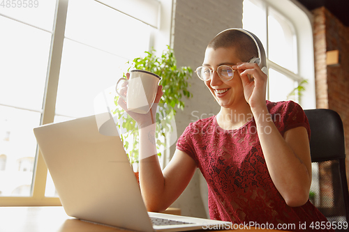 Image of Woman working from home during coronavirus or COVID-19 quarantine, remote office concept