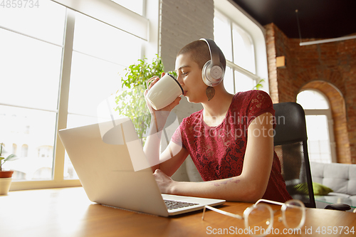 Image of Woman working from home during coronavirus or COVID-19 quarantine, remote office concept