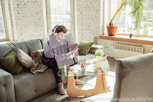 Image of Man working from home during coronavirus or COVID-19 quarantine, remote office concept