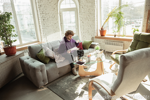 Image of Man working from home during coronavirus or COVID-19 quarantine, remote office concept