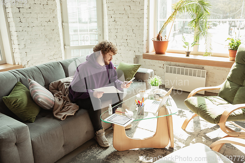 Image of Man working from home during coronavirus or COVID-19 quarantine, remote office concept