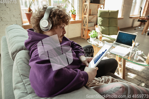 Image of Man working from home during coronavirus or COVID-19 quarantine, remote office concept