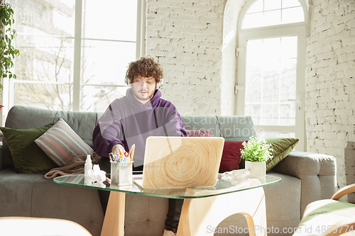 Image of Man working from home during coronavirus or COVID-19 quarantine, remote office concept