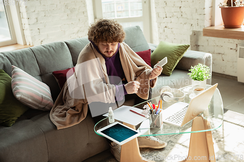 Image of Man working from home during coronavirus or COVID-19 quarantine, remote office concept