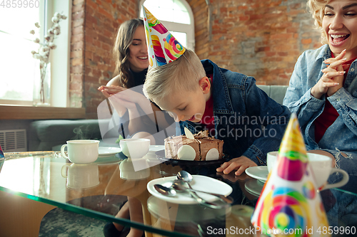 Image of Mother, son and sister at home having fun, comfort and cozy concept, celebrating birthday