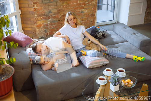 Image of Mother, father and son at home having fun, comfort and cozy concept