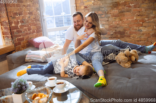 Image of Mother, father and son at home having fun, comfort and cozy concept