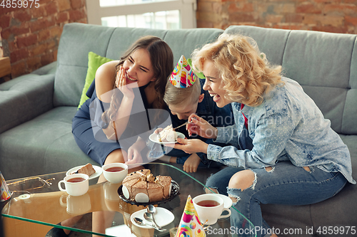 Image of Mother, son and sister at home having fun, comfort and cozy concept, celebrating birthday