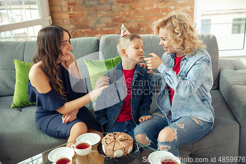 Image of Mother, son and sister at home having fun, comfort and cozy concept, celebrating birthday