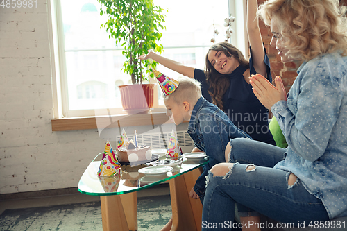 Image of Mother, son and sister at home having fun, comfort and cozy concept, celebrating birthday