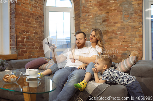 Image of Mother, father and son at home having fun, comfort and cozy concept