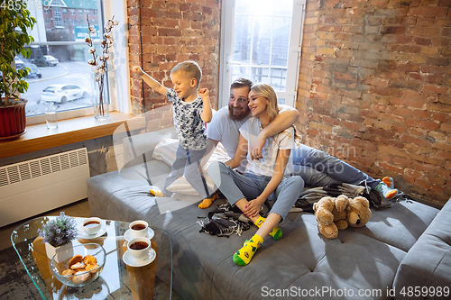 Image of Mother, father and son at home having fun, comfort and cozy concept