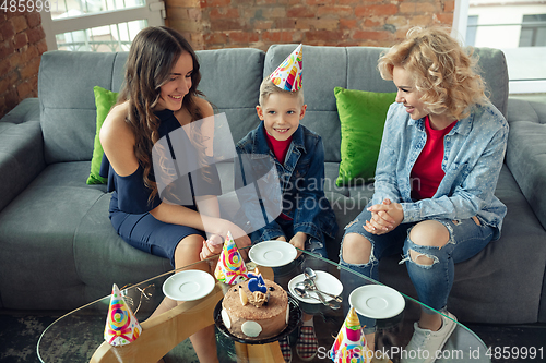 Image of Mother, son and sister at home having fun, comfort and cozy concept, celebrating birthday