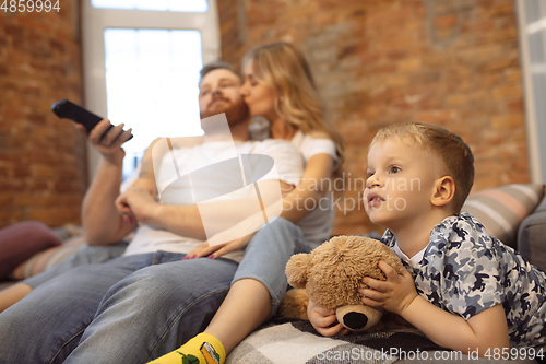 Image of Mother, father and son at home having fun, comfort and cozy concept