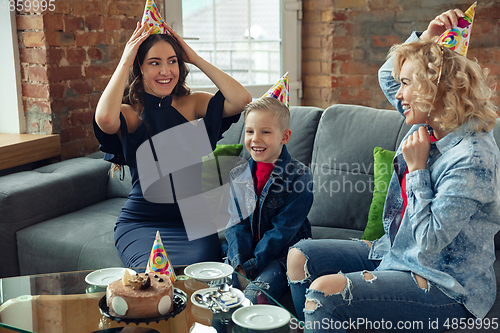 Image of Mother, son and sister at home having fun, comfort and cozy concept, celebrating birthday