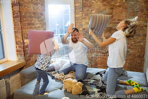 Image of Mother, father and son at home having fun, comfort and cozy concept