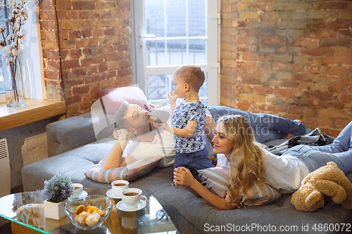 Image of Mother, father and son at home having fun, comfort and cozy concept