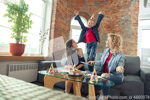 Image of Mother, son and sister at home having fun, comfort and cozy concept, celebrating birthday