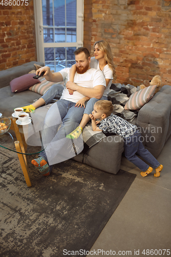 Image of Mother, father and son at home having fun, comfort and cozy concept