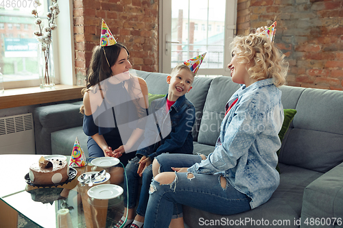 Image of Mother, son and sister at home having fun, comfort and cozy concept, celebrating birthday