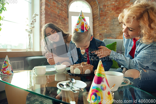 Image of Mother, son and sister at home having fun, comfort and cozy concept, celebrating birthday